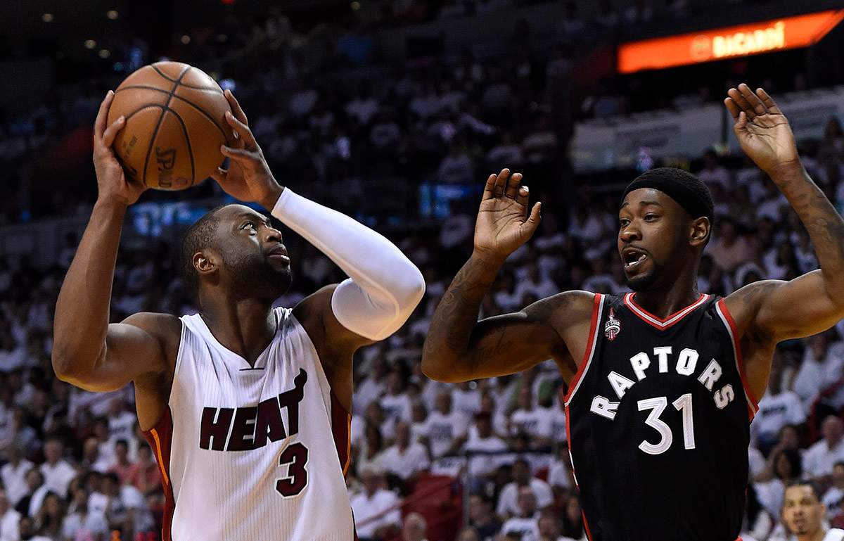 Miami Heat guard Dwyane Wade (L) is defended by Toronto Raptors guard Terrance Ross.