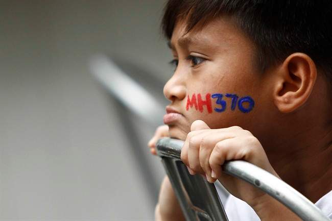 In this photo taken on Sunday, March 6, 2016, a Malaysian child with his face painted with MH370 during a remembrance event for the ill fated Malaysia Airlines Flight 370 in Kuala Lumpur, Malaysia. Malaysia’s government said Thursday that two more pieces of debris, discovered in South Africa and Rodrigues Island off Mauritius, were “almost certainly” from Flight 370, which mysteriously disappeared more than two years ago with 239 people on board.