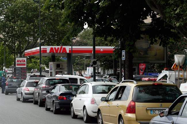 Drivers line up as they wait to buy gas in a station, in Paris, Tuesday, May 24, 2016. A two-month protest movement against a bill weakening France's famed worker protections reached a new level this week as fuel industry workers joined in. Strikes have spread to all eight of France's refineries, and one in five gas stations are now dry or running low.