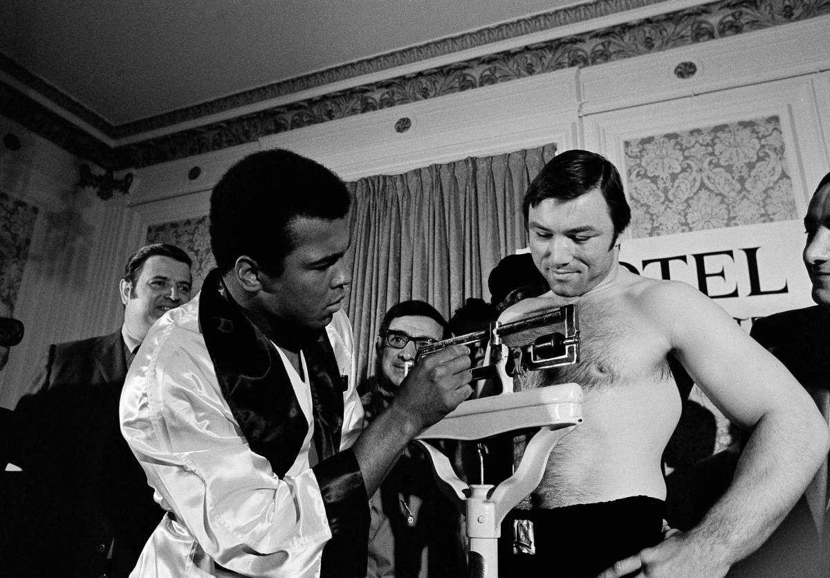 Muhammad Ali adjusts the scale for Toronto’s George Chuvalo at their weigh-in on May 1, 1972 in Vancouver. The two meet tonight in a 12 round heavyweight bout in Vancouver?s Coliseum. Ali weighed in at 217 ½ and Chuvalo at 221 pounds. (AP Photo)