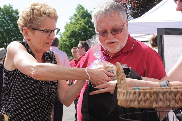 Liberal Leader Kathleen Wynne is seen at a farmer's market in Waterdown, Ont., on Saturday, June 7, 2014 with local Liberal member Ted McMeekin.