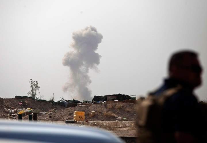 Smoke rises from a car bomb by Islamic State group on the front line in Fallujah, Iraq, Sunday, June 5, 2016.