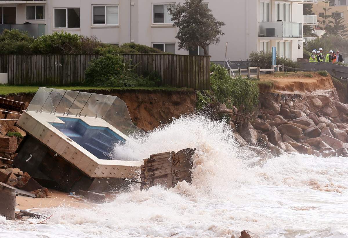 A swimming pool is dislodged and lays on a beach after storms undermined the pilings at Collaroy Beach in Sydney, Monday, June 6, 2016. Storms have lashed Australia’s easter coast for several days. (AP Photo/Rick Rycroft)