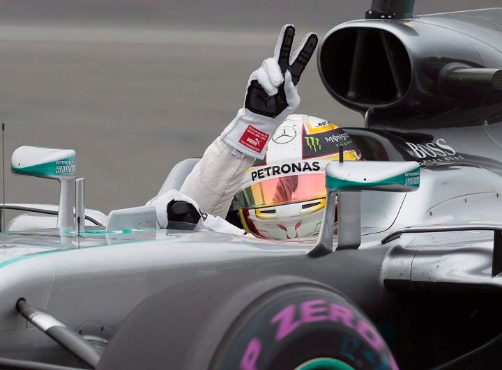 Mercedes driver Lewis Hamilton of Great Britain waves to the fans after winning the pole position in the qualifying session, Saturday, June 11, 2016 at the Canadian Grand Prix in Montreal. THE CANADIAN PRESS/Jacques Boissinot