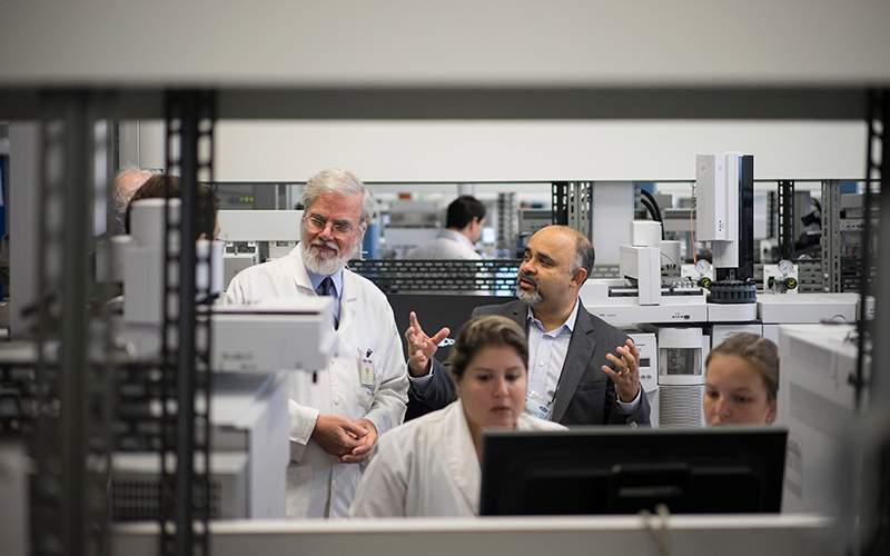 Brazil's Sports Minister George Hilton, top right, and Professor Francisco Radler, left, talk during Hilton's visit to the Brazilian Doping Control Laboratory (LBCD) in Rio de Janeiro, Brazil. 