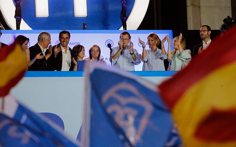 Spain's acting Primer Minister and candidate of Popular Party Mariano Rajoy, center, celebrates with party members the results of their party, during the national elections in Madrid, Spain, Sunday, June 26, 2016. 