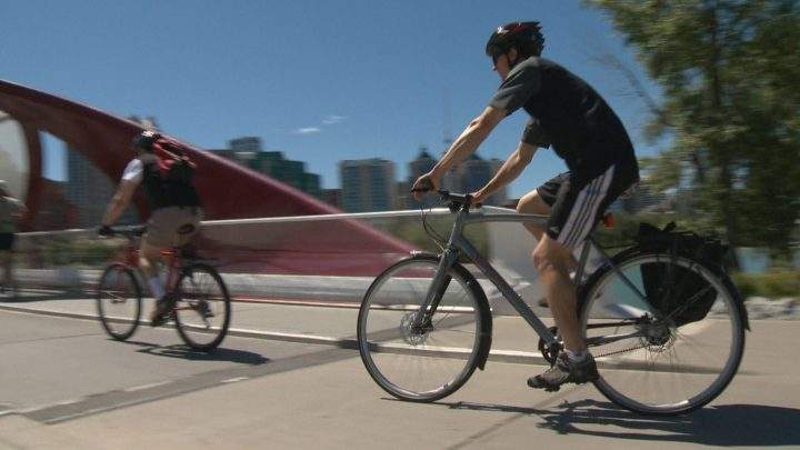 A Calgary couple cycle downtown during the noon hour on Wednesday. 