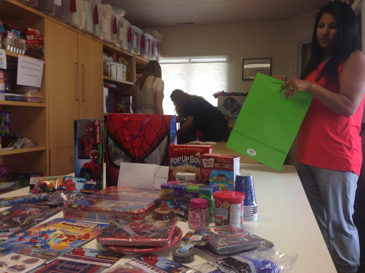 Volunteer Renu Chandarana (right) helps assemble birthday essentials for families in need as part of The Happy Birthday Project. 