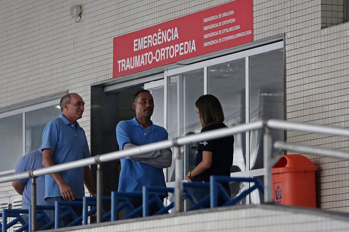 Employees stand in front an emergency entrance at the Souza Aguiar Hospital, in Rio de Janeiro, Brazil, Sunday, June 19, 2016. 