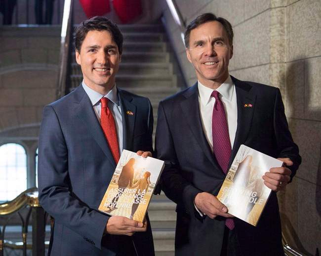 Prime Minister Justin Trudeau (left) walks with Minister of Finance Bill Morneau as he arrives to table the budget on Parliament Hill in Ottawa on March 22, 2016.