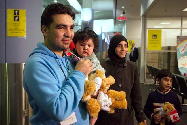 A family of Syrian refugees arrive at the Welcome Centre at Toronto's Pearson Airport on Friday December 18, 2015.