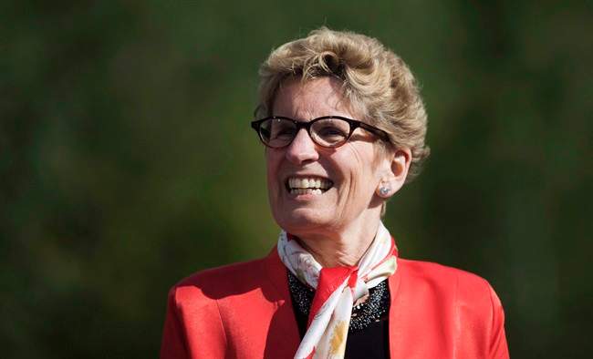 Ontario Premier Kathleen Wynne looks on before making a climate change policy announcement at Evergreen Brickworks in Toronto, Wednesday, June 8, 2016.