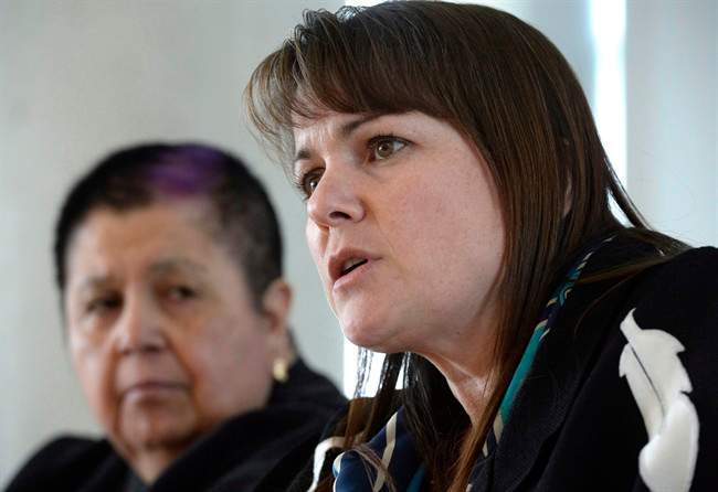 Dawn Lavell-Harvard, President of the Native Women's Association of Canada, speaks to reporters while Shelley McIvor of the Canadian Feminist Alliance for International Action listens on Jan. 31, 2016. Status of Women Canada will soon allow groups advocating for women and girls to receive federal project funding, reversing a controversial policy the previous Conservative government brought in nearly a decade ago.