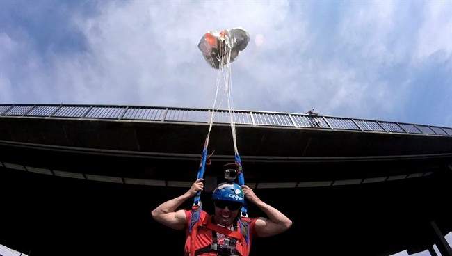 Sean Chuma is shown as he BASE jumps in this undated handout photo. Sean Chuma describes it as a spiritual moment, standing on the railing of the Perrine Bridge, 150 metres above the meandering Snake River in southern Idaho. Moments later, his mind completely focused on the present, he said he hurled himself into the stifling afternoon air. "I have a passion for flight," the BASE jumping enthusiast said by phone less than an hour later, having successfully completed the 3,767th jump of his career.