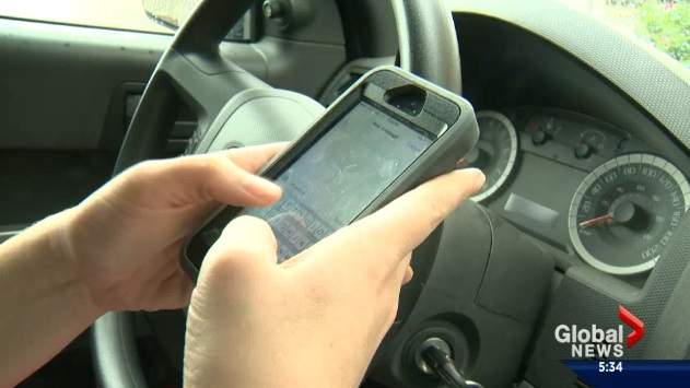File: A photo of a person distracted while driving.