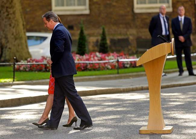 In this Friday, June 24, 2016 file photo, Britain's Prime Minister David Cameron and his wife Samantha walk back into 10 Downing Street, London, after speaking to the media. Cameron says he will resign by the time of the party conference in the fall after Britain voted to leave the European Union after a bitterly divisive referendum campaign, according to tallies of official results Friday.
