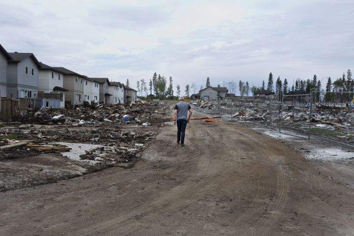 A Fort McMurray resident looks over the damage in the neighbourhood of Timberlea in Fort McMurray, Alta., on Wednesday June 1, 2016. Residents and business people returned after being evacuated during wildfires.