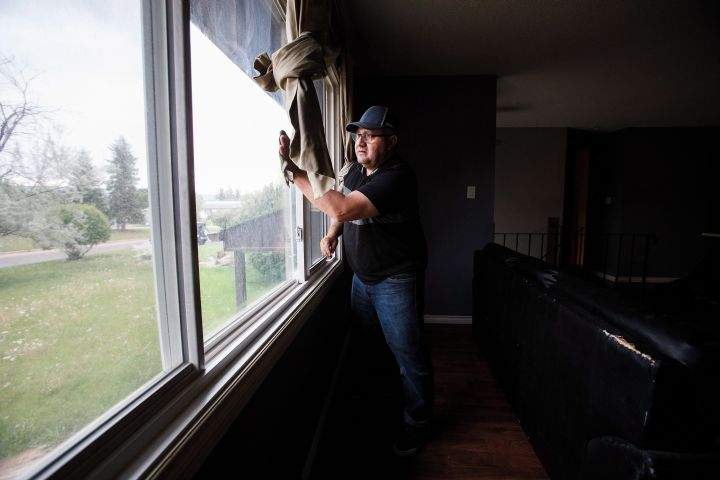 Polo Quinones scrubs his home after returning as residents re-enter fire-ravaged Fort McMurray, Alta., on Wednesday, June 1, 2016.