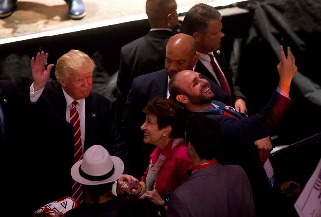 A man takes a selfie as Republican presidential candidate Donald Trump greets supporters after speaking at a rally at the Fox Theater, Wednesday, June 15, 2016, in Atlanta. 