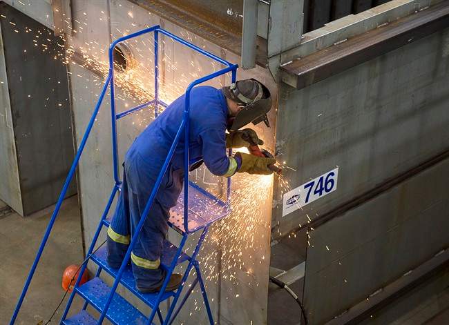A worker grinds a component at the Irving Shipbuilding facility in Halifax on Monday, June 13, 2016.