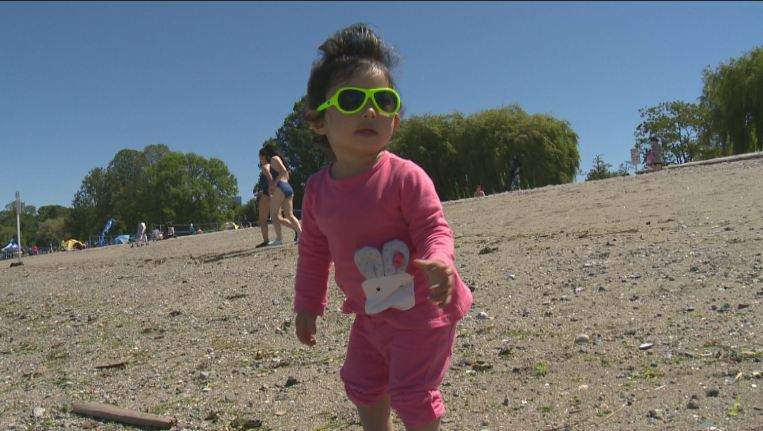 A small child enjoys the rays at Kits Beach on June 4, 2016, during Vancouver's warmest weekend of the year to date. 