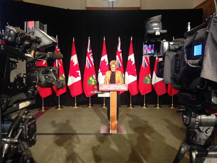 Premier Kathleen Wynne speaks to reporters at Queen's Park on June 21, 2016.
