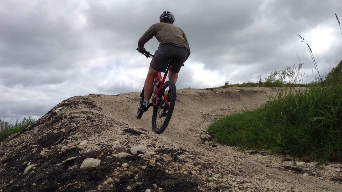 A biker cruises up the side of the trail which will be transformed into a mountain biking course at FortWhyte Alive.