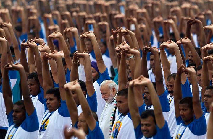 India’s Prime Minister Narendra Modi practices yoga along with thousands of Indians in Chandigarh, India, Tuesday, June 21, 2016.
