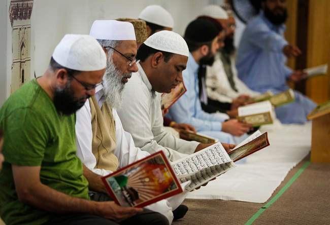 Men pray at a mosque in Calgary, Alta., Sunday, June 5, 2016.
