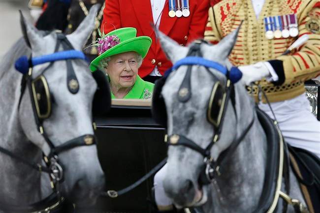 Britain\’s Queen Elizabeth II rides in a carriage during the Trooping The Colour parade at Buckingham Palace, in London, Saturday, June 11, 2016.