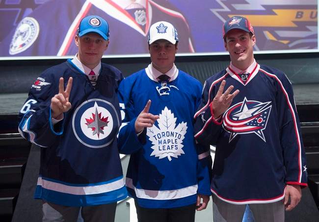 The NHL top three draft picks, left to right, Patrik Laine of the Winnipeg Jets, Auston Matthews of the Toronto Maple Leafs and Pierre-Luc Dubois of the Columbus Blue Jackets pose for a photo at the NHL draft in Buffalo, N.Y., on Friday, June 24, 2016. THE CANADIAN PRESS/Nathan Denette