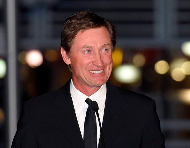 In this March 7, 2015 file photo, former NHLer Wayne Gretzky speaks to the crowd at a statue unveiling for former Kings left wing Luc Robitaille in Los Angeles. 