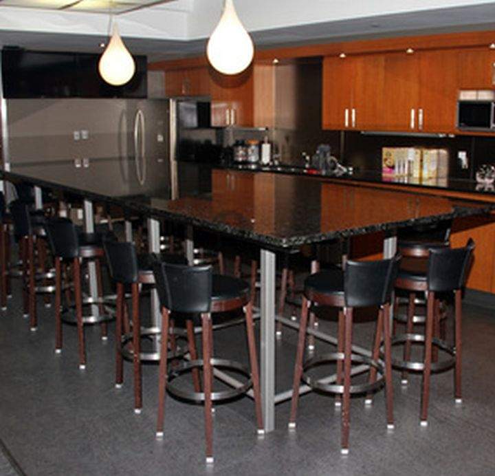 A massive granite table and 14 chairs which lived in the Edmonton Oilers players lounge are up for auction.