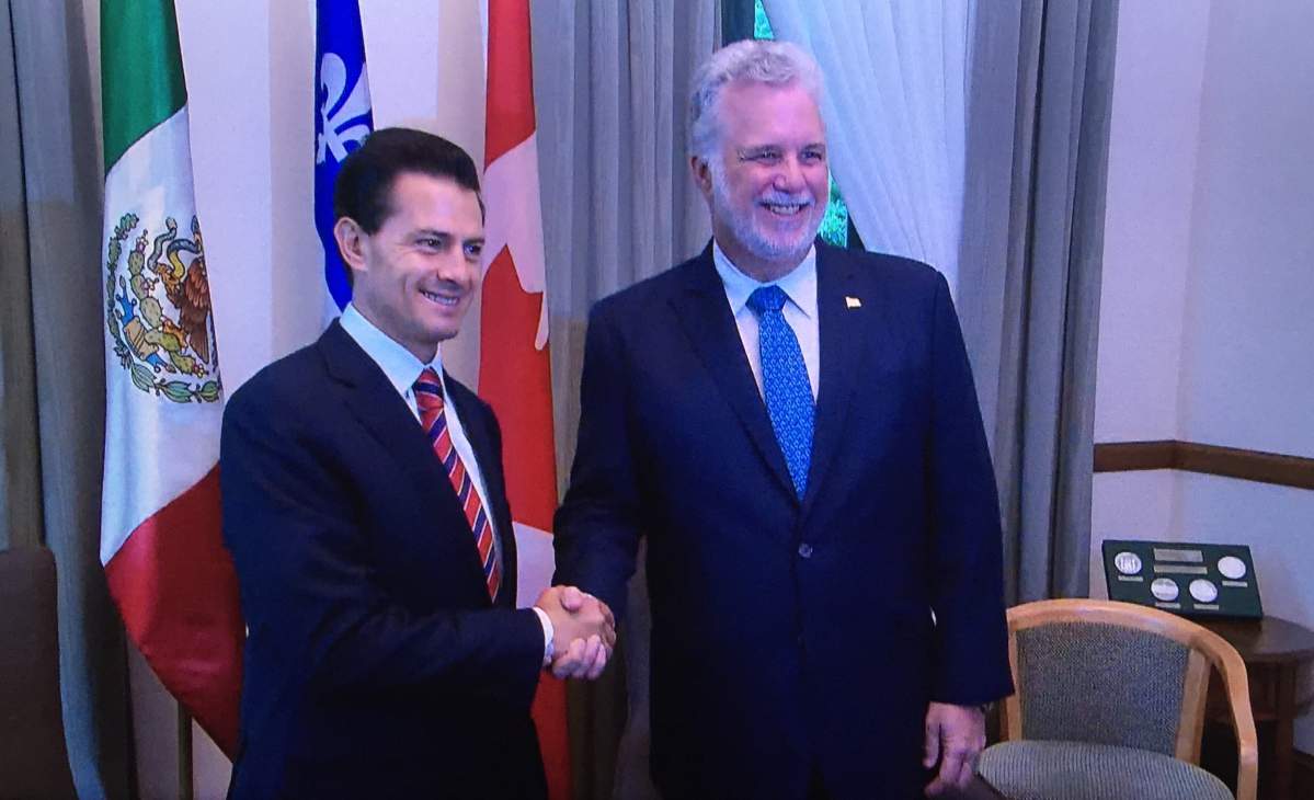 Quebec Premier Philippe Couillard shakes hands with Mexican President Enrique Peña Nieto, Monday, June 27, 2016.