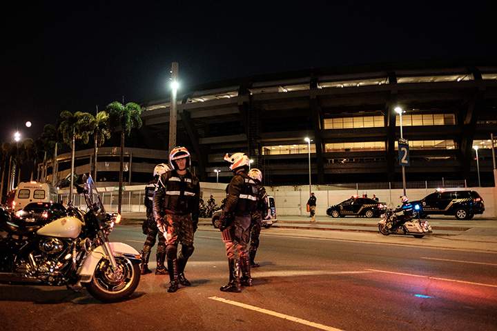 Brazilian federal police officers close the road during the security drill for the transfer of athletes at Maracana Stadium which will host soccer matches for Rio 2016 Olympic Games on June 19, 2016. 