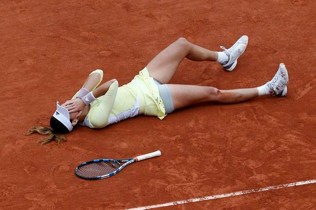 Spain's Garbine Muguruza falls on the clay as she defeats Serena Williams of the U.S. during their final match of the French Open tennis tournament at the Roland Garros stadium, Saturday, June 4, 2016 in Paris. 