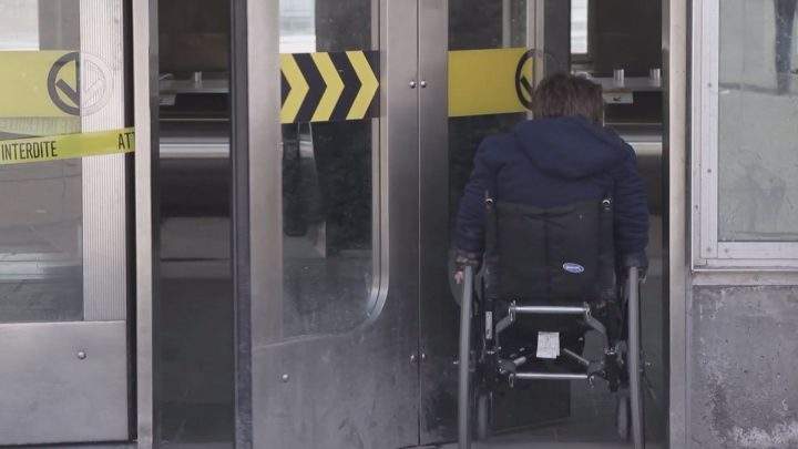 A person with reduced mobility enters a Montreal metro station.