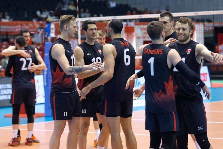 Canada's volleyball team members celebrate after a win over China during their Men's Volleyball World Olympic qualification tournament match in Tokyo, Sunday, June 5, 2016.