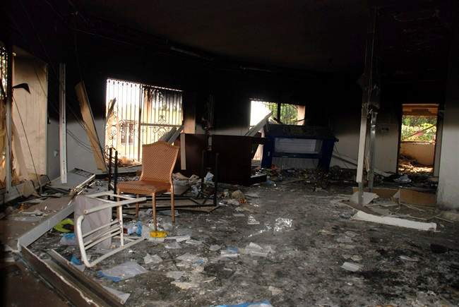 FILE - In this Sept. 12, 2012 file photo, glass, debris and overturned furniture are strewn inside a room in the gutted U.S. consulate in Benghazi, Libya, after an attack that killed four Americans, including Ambassador Chris Stevens. 
