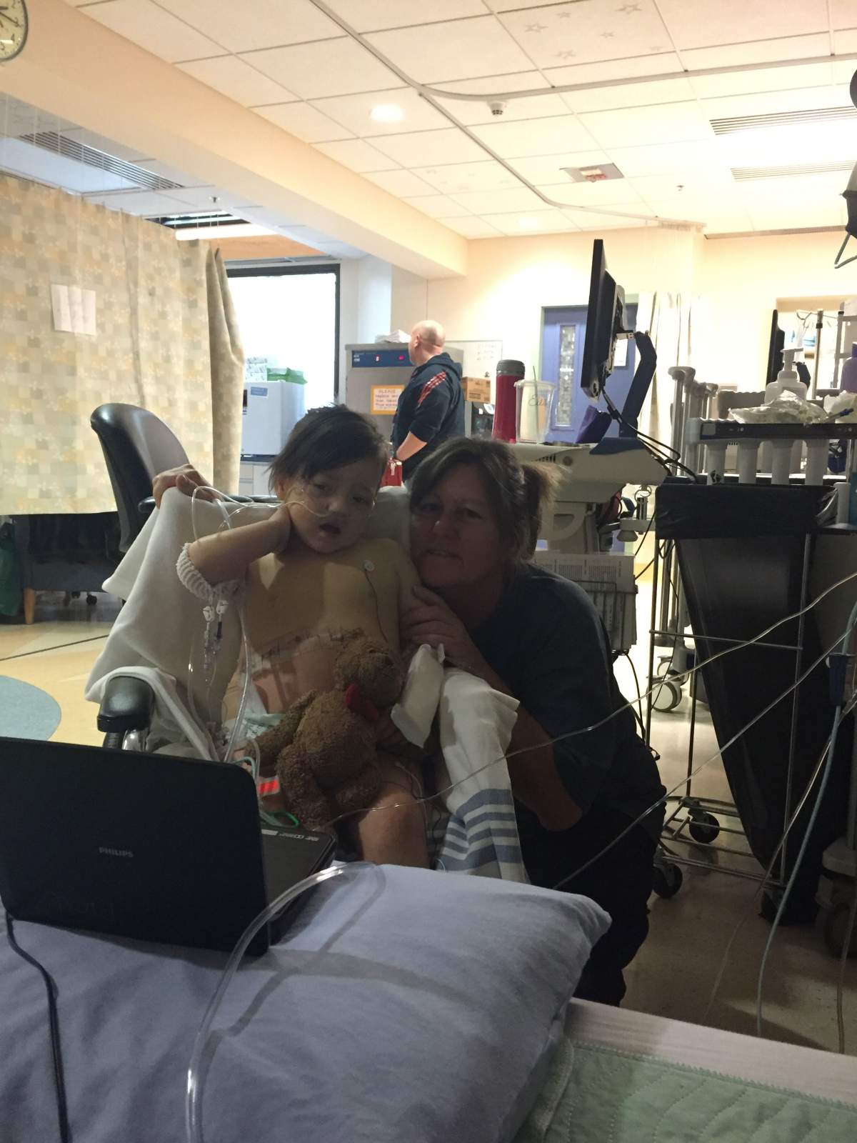 Aurora, seen here with Teddy, in the hospital for her liver transplant.