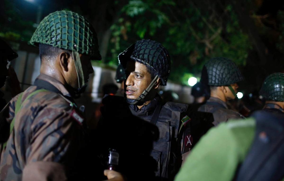 Bangladeshi security personnel stand guard near a restaurant that has reportedly been attacked by unidentified gunmen in Dhaka, Bangladesh, Friday, July 1, 2016. Local media reported that a group of attackers took hostages inside a restaurant frequented by both locals and foreigners in a diplomatic zone in Bangladesh’s capital.