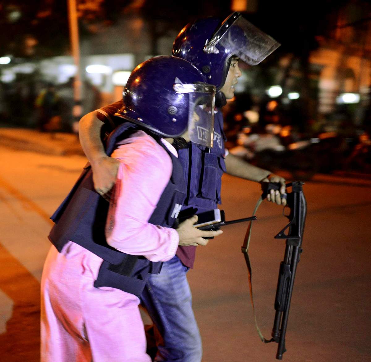 An unidentified security personnel is taken for medical attention after a group of gunmen attacked a restaurant popular with foreigners in a diplomatic zone of the Bangladeshi capital Dhaka, Bangladesh, Friday, July 1, 2016. A group of gunmen attacked a restaurant popular with foreigners in a diplomatic zone of the Bangladeshi capital on Friday night, taking hostages and exchanging gunfire with security forces, according to a restaurant staff member and local media reports. (AP Photo)