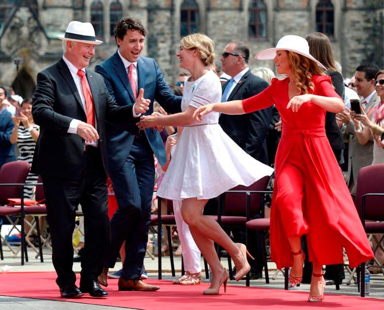 Governor General David Johnston, left to right, Prime Minister Justin Trudeau, Minister of Canadian Heritage Melanie Joly and Sophie Gregoire Trudeau dance during Canada Day celebrations on Parliament Hill.