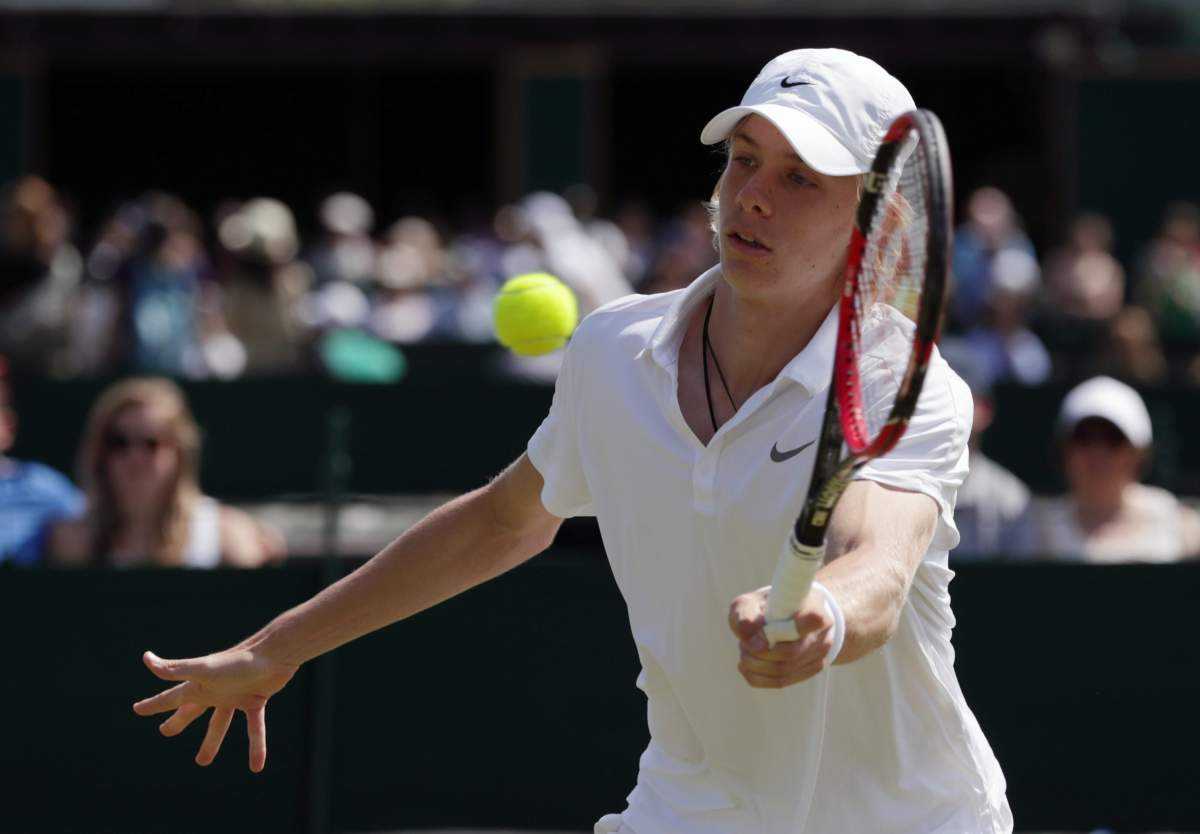 Denis Shapovalov of Canada plays a return to Yunseong Chung of Korea during their boy's singles match on day ten of the Wimbledon Tennis Championships in London, Wednesday, July 6, 2016. 
