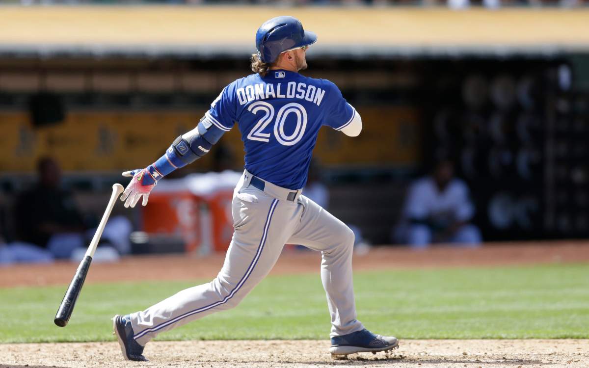 Toronto Blue Jays' Josh Donaldson swings for a two-run double off Oakland Athletics' John Axford in the ninth inning of a baseball game Sunday, July 17, 2016, in Oakland, Calif. 