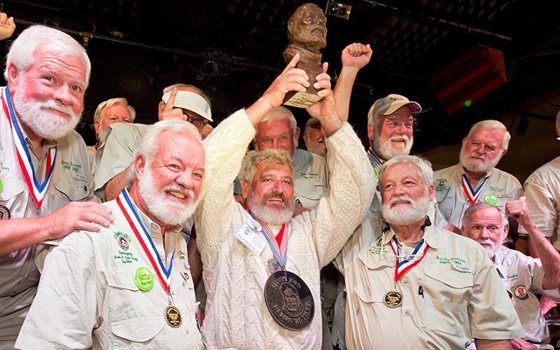 Dave Hemingway, center, hoists his trophy after winning the 2016 Ernest "Papa"  Hemingway Look-Alike Contest at Sloppy Joe's Bar in Key West, Fla.