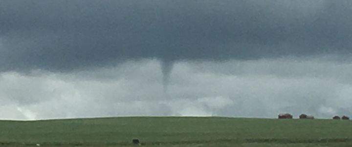 A funnel cloud is spotted near Airdrie, Alta. on July 16, 2016.