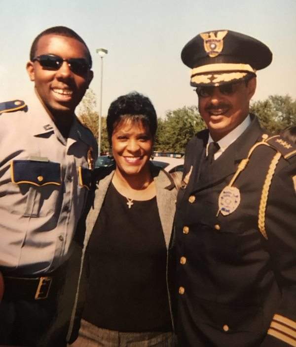 In this undated photo provided by Trenisha Jackson, her husband, Baton Rouge Police Officer Montrell Jackson, from left, his aunt Darlene Cavalier and former Baton Rouge Police Chief Jeff LeDuff pose for a photo at a graduation ceremony to become a police officer in Baton Rouge, La.
