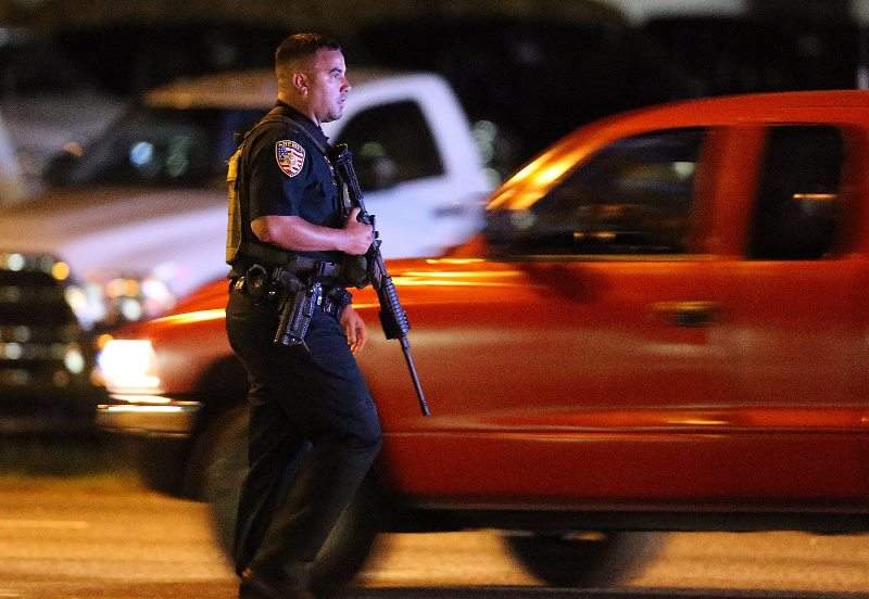 A police officer works the scene near where multiple Baton Rouge police officers were killed on Sunday, July 17, 2016, in Baton Rouge, La. (Curtis Compton/Atlanta-Journal Constitution via AP)