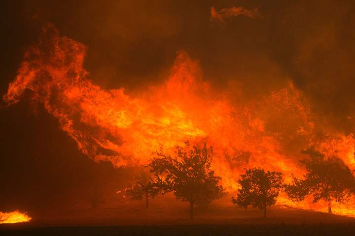 Flames blown by strong winds close in on homes at the Sand Fire on July 23 2016 near Santa Clarita, California.